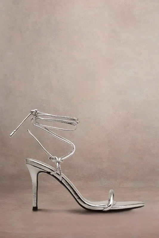 Wedding guest dresses with pom - pom trims for a playful look Crossed Wires | Silver Metallic Lace-Up Heeled Sandals