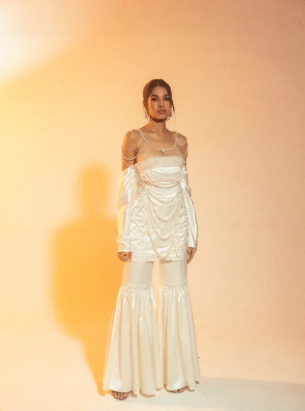 Holiday dresses with tiered and ruffled sleeves and a flared skirt for a voluminous and feminine holiday style Nadira White Pearl Hand-Embroidered Sharara Set Holiday dresses with tiered and ruffled sleeves and a flared skirt for a voluminous and feminine holiday style Nadira White Pearl Hand-Embroidered Sharara Set